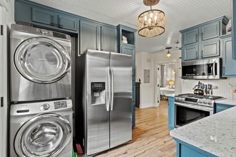 Full kitchen with stone counters and stainless steel appliances 