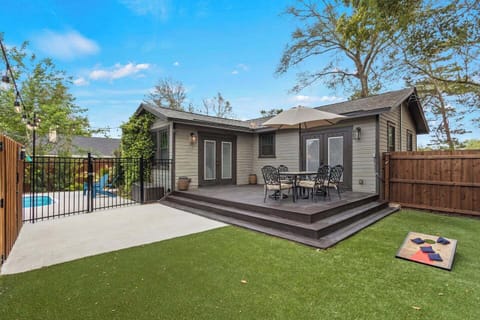 Fenced back yard with pool and separated large deck and astro turf