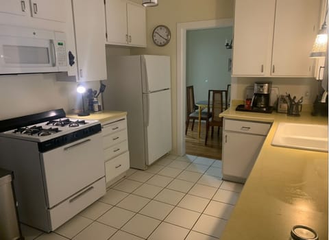 The kitchen is in the middle of the house with three entry points, including one to the dining room.