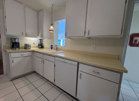 The kitchen has everything you need to cook at home, including a new gas range and dishwasher.