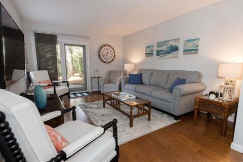 The open layout connects seamlessly to the dining area, creating a welcoming space for unwinding after a day at the beach.