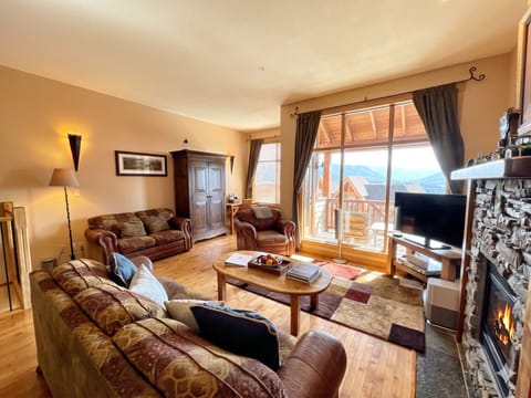Time to kick back and relax in this spacious, cozy living area.  The door leads out to the front BBQ deck.  Cable TV and Natural Gas Fireplace.