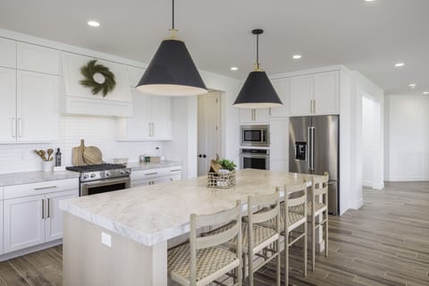 Kitchen Island Side View - This sleek, modern kitchen has all the best upgrades to make cooking a breeze!