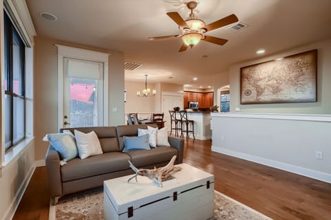 Open living space includes a leather sleeper sofa and two plush armchairs (not pictured)