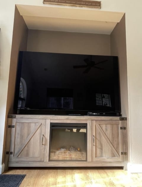 65 in' TV with electric fireplace.