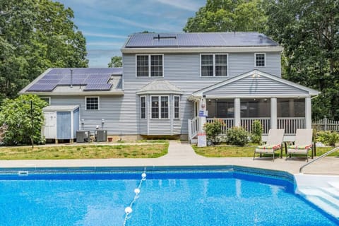 Inviting backyard oasis with a sparkling pool and ample outdoor seating for the perfect Cape escape