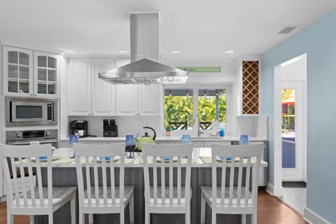 Kitchen Oasis: Bright counters and palm views make cooking a delight for all!

