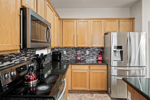 Stainless-steel appliances, electric stove w/oven, microwave, and dishwasher.