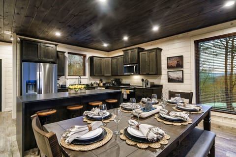 Seating for 8 at the dinner table + 4 at the island + 3 at the bar table.