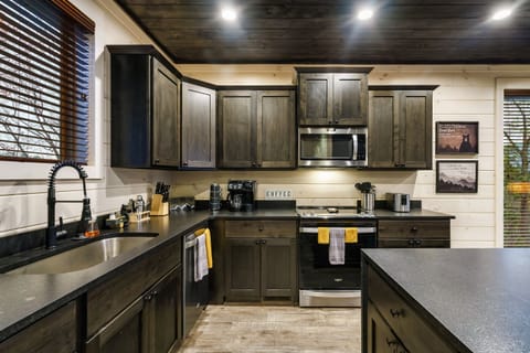 The open kitchen is stocked with pots and pans + one of 3 coffee stations.