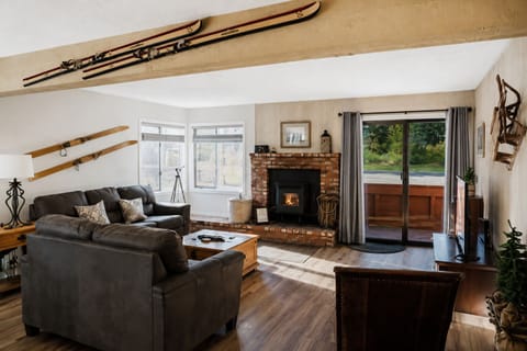 Mountain inspired living space with comfortable seating by the fireplace
