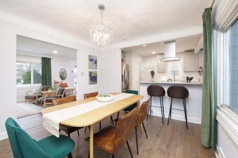 - Spacious dining room with seating for family meals   - Modern chandelier lighting and large windows   - Stylish space great for dinners and entertaining  