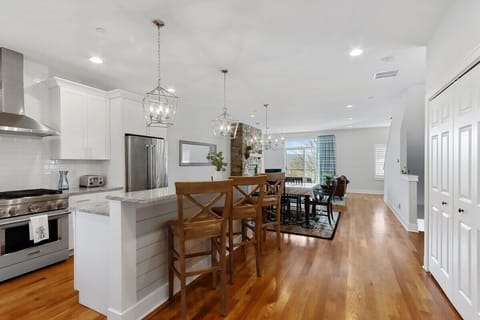 Open concept kitchen, dining to living room.