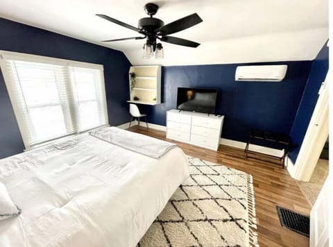 Large master bedroom with smart TV and desk area!