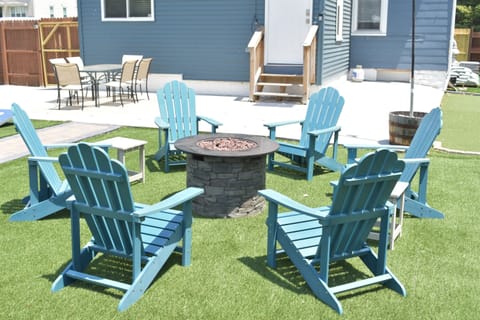 Make memories around the gas firepit with Adirondack-chair seating for 6.