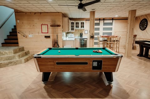 Gather downstairs in the massive game room that's stocked with pool, shuffleboard, checkers, a movie area, and a kitchenette.