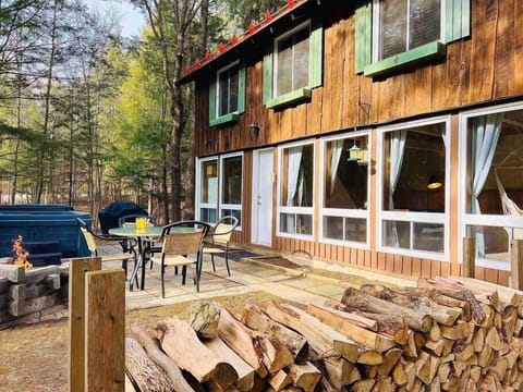 View of the exterior with hot tub and fire place