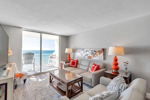 Inviting living room w/ coastal decor, comfy seating, & natural light throughout.
