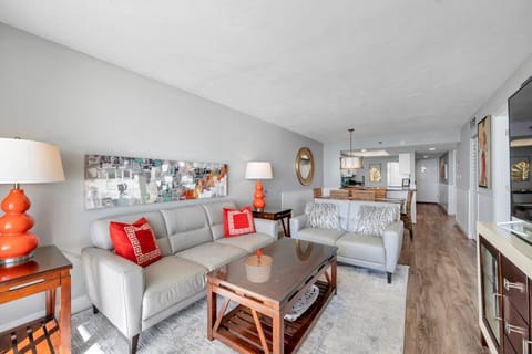 Inviting living room w/ comfy seating, coastal accents, & an open flow into the kitchen.