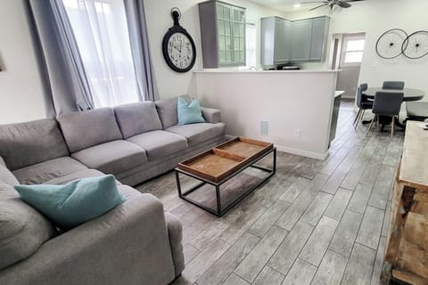 View of the living room looking into the kitchen and dining area. The house has an open layout making it easy to talk with the people in the kitchen.