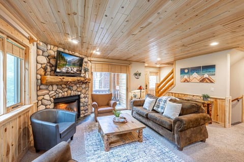 Welcome to the inviting Timberwolf home. The cozy living room features a comfortable seating and a warm gas fireplace