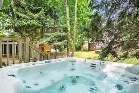 Relax in the private hot tub overlooking the trees at Beach Glass