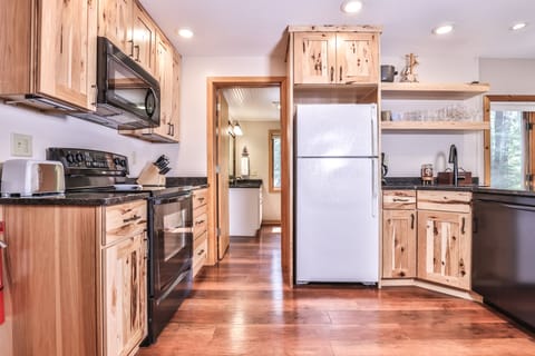 Modern appliances blend gorgeously giving this kitchen a rustic charm.