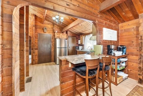 An open archway and furry bar stools allows for good kitchen conversations,