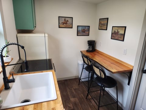 Kitchen: stools, live edge bar, coffee & tea, garbage disposal, pots and pans