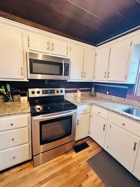 Stainless appliances, granite countertops, fully stocked kitchen.