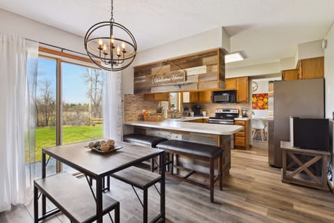 Dining area for eight: four at the table and 4 can sit at the kitchen peninsula.