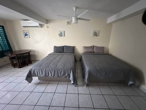 Spacious room with two full beds and place for dinner.