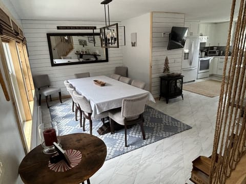 Dining room with a table set for 8 but can squeeze 10 people 