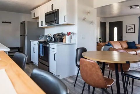 Looking from the bar top into the kitchen, dining area, and living room. 