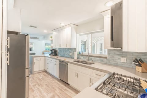 Whip up delicious meals in our clean and functional kitchen!  Featuring a gas range and stainless steel fridge with filtered water, everything you need for a home-cooked experience. ‍‍