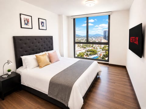 Comfortable, spacious master bedroom with a queen-size bed. Stylish, minimalistic decor and stunning city views. Soundproof windows ensure a peaceful environment. Enjoy a restful night's sleep with blackout and privacy drapes.