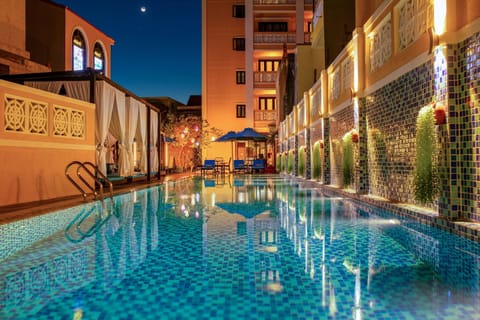 Outdoor pool, open 6:30 AM to 9:30 PM, pool umbrellas