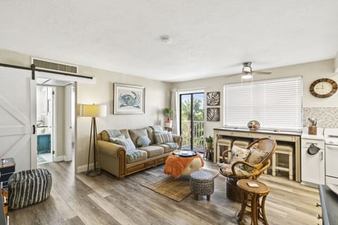 Initial entrance into #106 overlooking an open living room and kitchen layout.