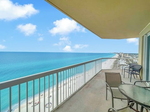The expansive wraparound balcony showcases breathtaking panoramic views of the Gulf and Panama City Beach shoreline.