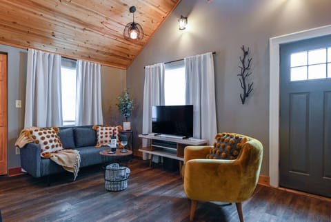 Relax in your stylish living space featuring exposed wood beams, plush seating, and thoughtful design touches that create the perfect atmosphere for unwinding.