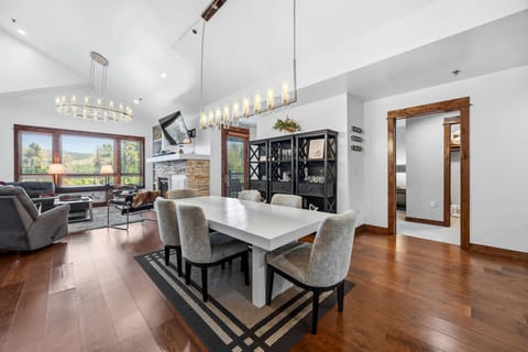 Penthouse great room with cathedral ceilings + stacked-stone gas fireplace
