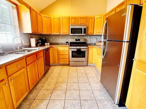 Gourmet kitchen with quartz countertops and stainless steel appliances.