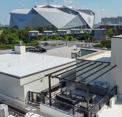 Private balcony w/ seating area overlooking city buildings & unique architecture
