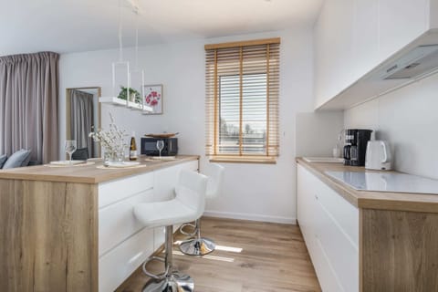 A modern kitchen with all essential appliances and wooden cabinets.