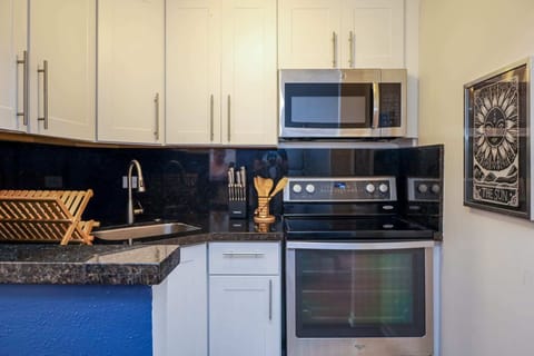 Our kitchen is a delightful nook of culinary charm, perfect for whipping up beachside snacks or intimate meals.