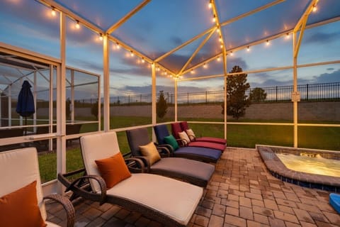 Pool, spa and screened patio at twilight