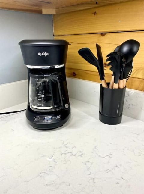 Kitchen is stocked with coffee maker and all the cooking utensils needed.
