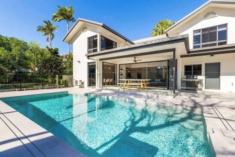 The stunning backyard houses a sparkling in-ground pool.