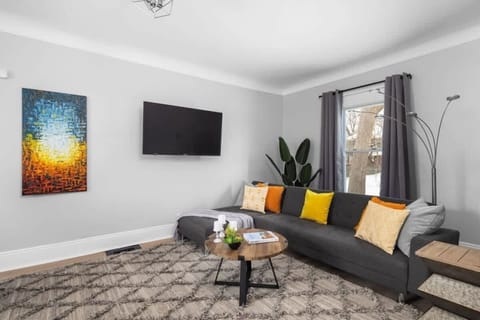 Comfortable living room with sectional sofa and smart TV.