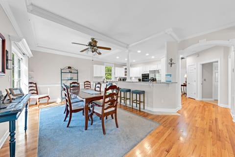 The dining area is open to the kitchen. The breakfast bar has stool seating